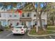 Inviting townhome with light blue shutters, a matching front door, and a dedicated parking space at 8615 Hunters Key Cir, Tampa, FL 33647