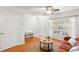Bright and airy living room showcasing hardwood floors and natural light from a large window at 8615 Hunters Key Cir, Tampa, FL 33647