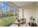 Cozy screened patio with outdoor seating and view of the surrounding greenery at 8615 Hunters Key Cir, Tampa, FL 33647