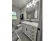 Updated bathroom featuring a vanity with marble countertop, modern fixtures, and tiled floors at 907 Knollwood Dr, Dunedin, FL 34698