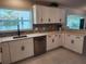 Beautifully designed kitchen with quartz counters and modern backsplash, stainless steel appliances, and ample storage at 907 Knollwood Dr, Dunedin, FL 34698