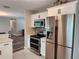 Modern kitchen featuring stainless steel appliances and gray backsplash at 907 Knollwood Dr, Dunedin, FL 34698