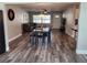 Cozy living room featuring wood floors, dining table, and view to the front door and kitchen at 907 Knollwood Dr, Dunedin, FL 34698