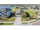 Aerial view of house showcasing large front yard, garage and surrounding community at 9805 Lemon Drop Loop, Sun City Center, FL 33573