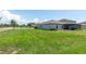 Spacious backyard featuring lush green grass and covered lanai, perfect for outdoor activities at 9805 Lemon Drop Loop, Sun City Center, FL 33573