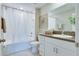 Bright bathroom with white vanity, shower and tub at 9805 Lemon Drop Loop, Sun City Center, FL 33573