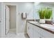 Bathroom featuring double sinks, granite countertops, and white cabinetry at 9805 Lemon Drop Loop, Sun City Center, FL 33573