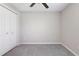 Neutral bedroom with ceiling fan, carpet flooring, and closet at 9805 Lemon Drop Loop, Sun City Center, FL 33573