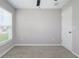 Neutral bedroom with ceiling fan, carpet flooring, and bright window at 9805 Lemon Drop Loop, Sun City Center, FL 33573