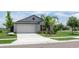 Charming single-story home with a two-car garage, well-maintained lawn, and lush landscaping at 9805 Lemon Drop Loop, Sun City Center, FL 33573