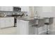 Modern kitchen island with granite countertops and barstool seating for casual dining at 9805 Lemon Drop Loop, Sun City Center, FL 33573