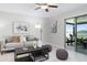 Bright living room with sliding glass door leads to a covered patio and backyard view at 9805 Lemon Drop Loop, Sun City Center, FL 33573