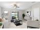 Inviting living room with ceiling fan and sliding glass doors to the outside at 9805 Lemon Drop Loop, Sun City Center, FL 33573