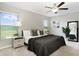 Comfortable main bedroom features a ceiling fan and backyard view at 9805 Lemon Drop Loop, Sun City Center, FL 33573