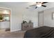 Main bedroom with ceiling fan and adjoining bathroom at 9805 Lemon Drop Loop, Sun City Center, FL 33573