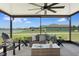 Covered outdoor seating area offers lake views at 9805 Lemon Drop Loop, Sun City Center, FL 33573