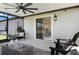 Covered patio features comfortable seating, lake views and easy access to the house at 9805 Lemon Drop Loop, Sun City Center, FL 33573
