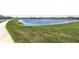 Community pond with lush green surroundings and a walking path, great for scenic strolls at 9805 Lemon Drop Loop, Sun City Center, FL 33573