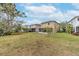 Expansive backyard featuring a spacious lawn and partially screened patio, ideal for outdoor entertaining at 10815 Wrigley Ct, Riverview, FL 33579