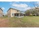 Wide backyard with screened patio featuring a lawn area, providing ample space for relaxation and outdoor activities at 10815 Wrigley Ct, Riverview, FL 33579