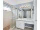 Bathroom featuring glass enclosed tiled shower, toilet, and white vanity at 10815 Wrigley Ct, Riverview, FL 33579