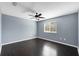 Bedroom featuring hardwood floors, window with blinds, and ceiling fan with light at 10815 Wrigley Ct, Riverview, FL 33579