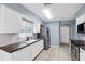 The kitchen features white cabinets, stainless steel appliances, tile backsplash, and a dark countertop at 10815 Wrigley Ct, Riverview, FL 33579