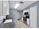 Modern kitchen features white cabinetry, stainless steel appliances, tile flooring, and dark countertops at 10815 Wrigley Ct, Riverview, FL 33579