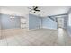 Open floor plan features a dining area, tile floors, neutral paint, and a staircase to the second level at 10815 Wrigley Ct, Riverview, FL 33579