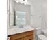 Well-lit bathroom with a wood-finished vanity, a clean white countertop, and a modern faucet for a stylish touch at 12660 Glenn Creek Dr, Riverview, FL 33569