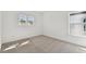 Bright bedroom with neutral carpet, two large windows that offer plenty of natural light, and fresh white walls at 12660 Glenn Creek Dr, Riverview, FL 33569
