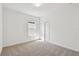 Bright bedroom features neutral carpet, one window, white walls, and a closet with sliding doors at 12660 Glenn Creek Dr, Riverview, FL 33569