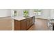 Open-concept kitchen with hardwood floors, white countertops and cabinets, and stainless steel appliances at 12660 Glenn Creek Dr, Riverview, FL 33569