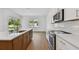 Open concept kitchen with stainless steel appliances, hardwood floors, and access to outdoor patio at 12660 Glenn Creek Dr, Riverview, FL 33569