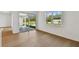 Sun-filled living area featuring hardwood floors, large windows, and sliding glass door access to the patio at 12660 Glenn Creek Dr, Riverview, FL 33569