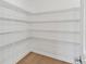 Walk-in pantry with wire shelving and wood floor; perfect for storage and organization at 12660 Glenn Creek Dr, Riverview, FL 33569