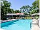 Community pool area with chairs and tables, perfect for relaxation and enjoying the outdoors at 1510 Palmer Ct, Palm Harbor, FL 34685