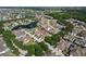 Aerial view of a community featuring water views, lush landscaping, and cozy homes with spacious driveways at 217 Oceania Ct, Apollo Beach, FL 33572