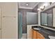 Bathroom features a modern vanity, patterned wallpaper, and sleek glass-enclosed shower at 217 Oceania Ct, Apollo Beach, FL 33572