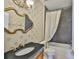 Bathroom features a shower and tub combo with ornate mirror and wallpaper at 217 Oceania Ct, Apollo Beach, FL 33572