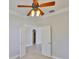 Neutral bedroom features tile floors, a lighted ceiling fan, and an open doorway at 217 Oceania Ct, Apollo Beach, FL 33572