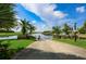 Community boat ramp leads to a beautiful lake with palm trees lining the shore under a blue sky at 217 Oceania Ct, Apollo Beach, FL 33572
