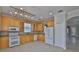 Well-lit kitchen with ample cabinet space, modern appliances, and a stylish chandelier at 217 Oceania Ct, Apollo Beach, FL 33572