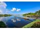 Lake view featuring a dock with canoes and trees in the background at 217 Oceania Ct, Apollo Beach, FL 33572