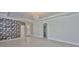 Open living room boasts stylish wallpaper, arched doorways, and tile flooring at 217 Oceania Ct, Apollo Beach, FL 33572