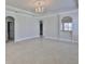 Open living area with a decorative chandelier, archways, and neutral tones, creating an inviting space at 217 Oceania Ct, Apollo Beach, FL 33572