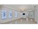 Spacious living room with large windows, tile floor and modern lighting fixture at 217 Oceania Ct, Apollo Beach, FL 33572