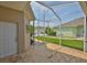 Back porch with brick flooring looking out onto the lawn and neighboring homes at 217 Oceania Ct, Apollo Beach, FL 33572