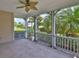 Back porch with ceiling fan looking out onto mature landscaping at 217 Oceania Ct, Apollo Beach, FL 33572
