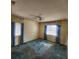 Bedroom featuring carpet flooring, a ceiling fan, and two windows at 2241 Greenwich Dr # 68, Sun City Center, FL 33573